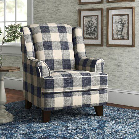 a blue and white checkered chair sitting on top of a rug