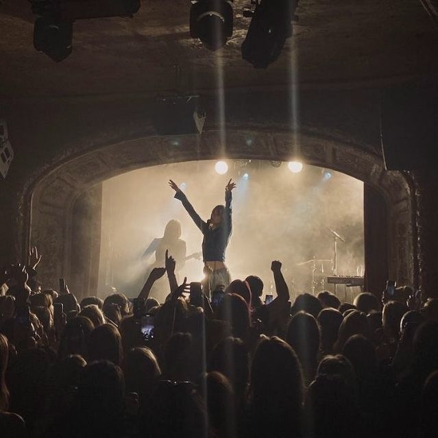 a man standing on top of a stage in front of a crowd