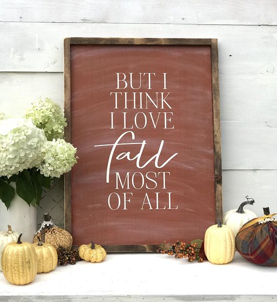 a sign that says, but i think i love fall most of all next to some pumpkins