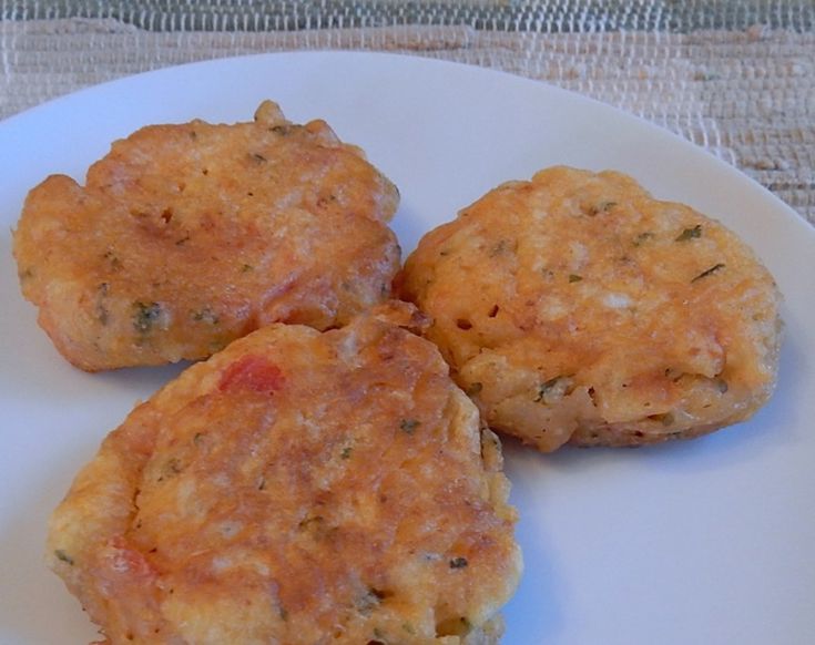 three crab cakes on a white plate