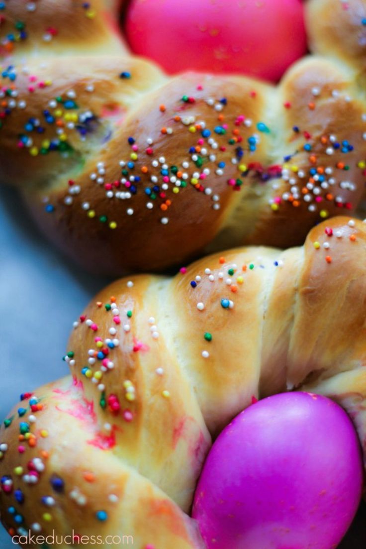 several braided breads with colorful sprinkles and an easter egg in the middle