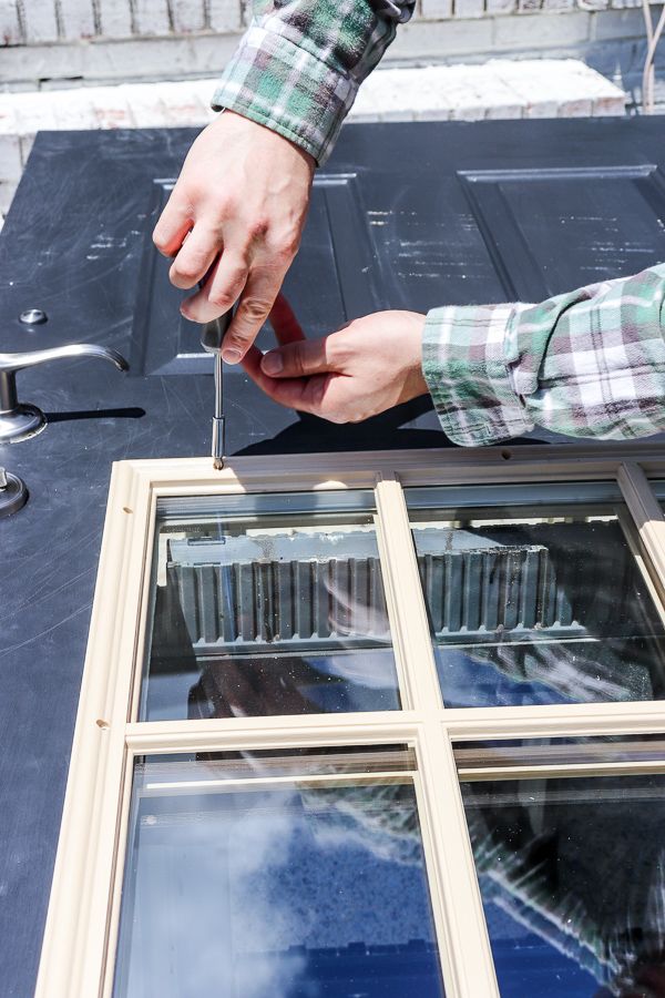 a person is cutting through the glass on top of a roof with a pair of scissors