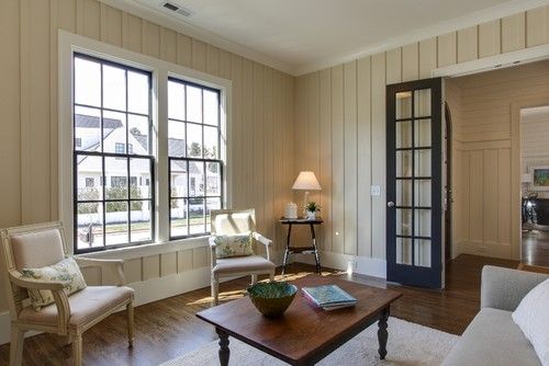 a living room filled with furniture and windows