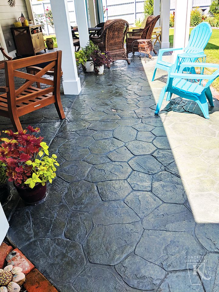 a patio with chairs and potted plants on it