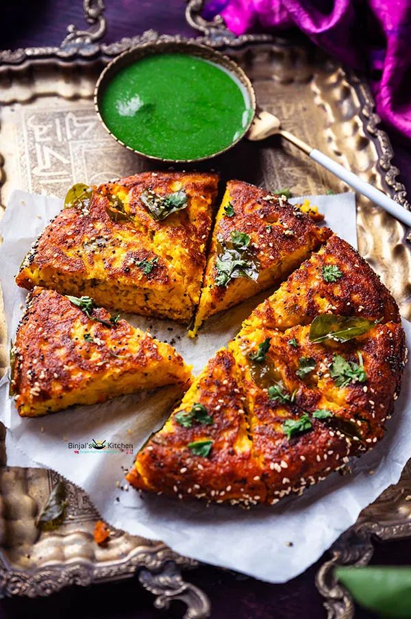 a plate with some food on it next to a green sauce