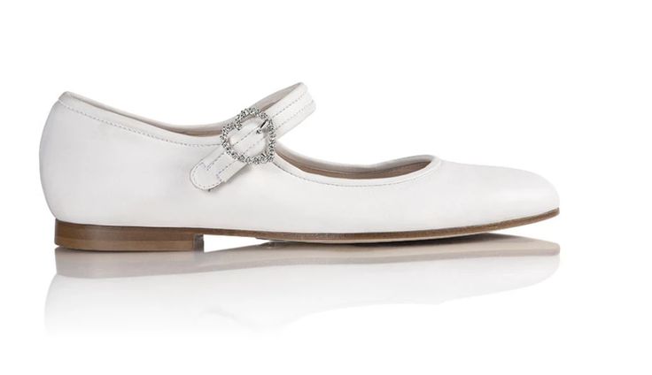 Our new flat Mary Jane, with a heart-shaped Swarovski buckle. Elegant Evening Ballet Flats With Buckle Closure, Chic White Closed Toe Mary Janes, Elegant Cream Ballet Flats With Removable Insole, Elegant Ballet Flats With Buckle Closure, Elegant White Ballet Flats With Removable Insole, White Flat Heel Mary Janes With Buckle, Elegant White Round Toe Ballet Flats, Elegant White Pointed Toe Mary Janes, Elegant White Ballet Flats