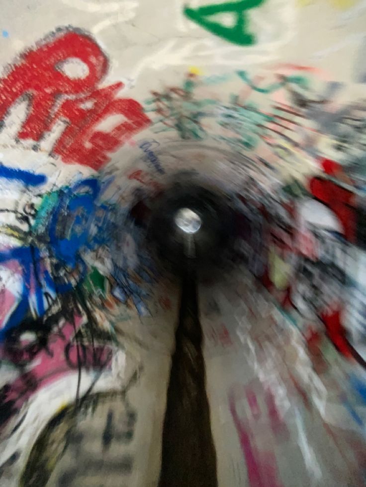 the inside of a subway tunnel with graffiti all over it