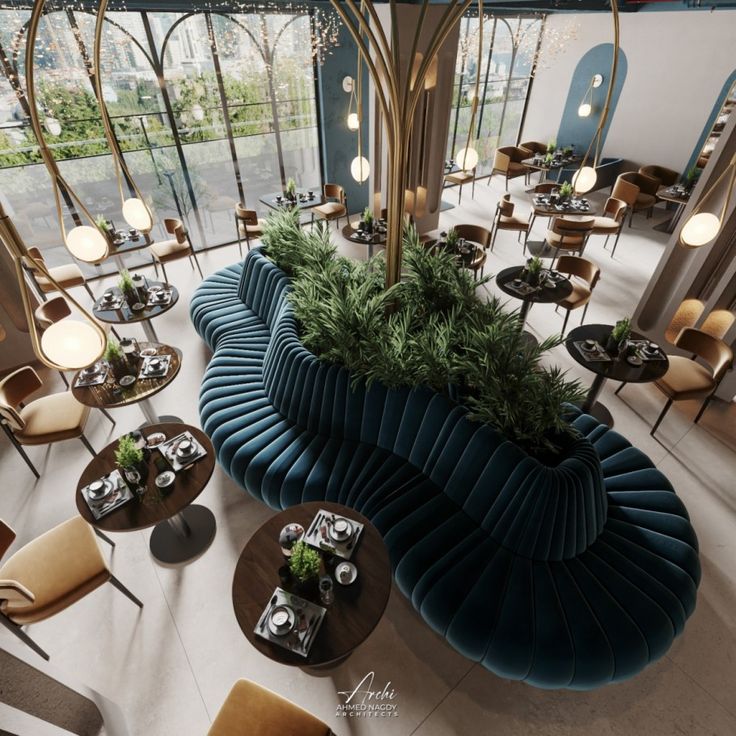 the interior of a restaurant with many tables and chairs, plants on top of it