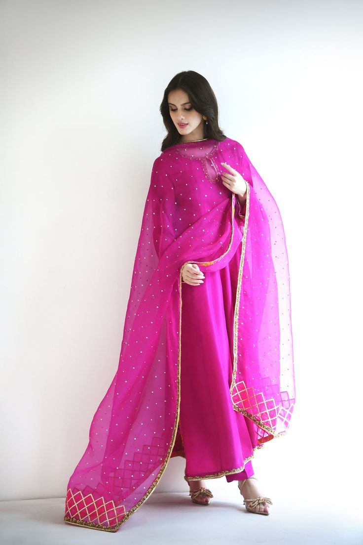 Meticulously crafted from a remarkably glamourous shade of magenta ( pure raw silk 60 gms )“ Zabe “ with its intricate hand crafted details strikes the perfect balance between elegant and eye-catching, making this beautiful design a must have. The length of the kalidaar is 48 inches.Agha Noor’s style tip - “ Dress it u Elegant Traditional Wear With Gota Work For Designer Wear, Elegant Traditional Wear With Gota Work, Elegant Traditional Wear With Gota Work For Diwali, Elegant Purple Salwar Kameez With Zari Work, Festive Elegant Salwar Kameez With Cutdana, Elegant Floor-length Traditional Wear With Gota Work, Elegant Designer Salwar Kameez With Gota Work, Elegant Floor-length Kurta With Cutdana, Elegant Floor-length Cutdana Kurta