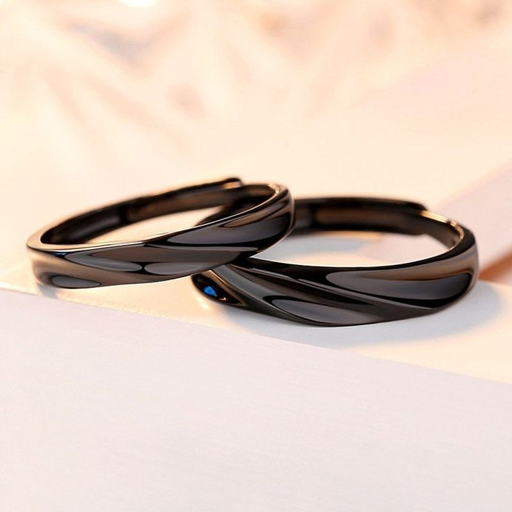 two black rings sitting on top of a white surface