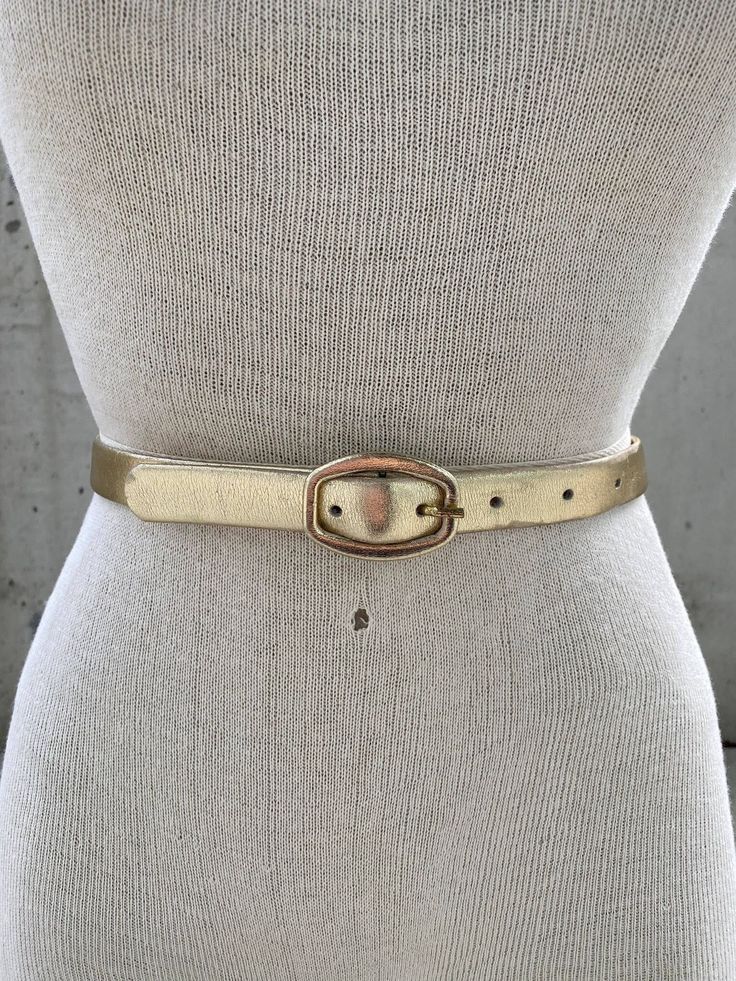 Vintage Karl Olsen gold tone leather belt, thin golden belt, made in Britain, Dorset fashion accessories, shiny metallic gold, designer belt This Vintage Karl Olsen Gold Tone Leather Belt is a timeless piece of British fashion accessory that exudes sophistication and elegance. Crafted with meticulous attention to detail, this belt features a thin golden belt made of leather and finished in a shiny metallic gold tone that adds a touch of opulence to any outfit. The designer behind this exceptional belt, Karl Olsen, is widely known for his mastery in creating stunning leather accessories that embody quality, style, and durability. With a keen eye for design, Olsen has established himself as one of Britain's most celebrated fashion accessory designers, with a reputation for delivering top-not Golden Belt, Designer Belt, British Fashion, Suspender Belt, Gold Leather, British Style, Leather Accessories, Metallic Gold, Timeless Pieces