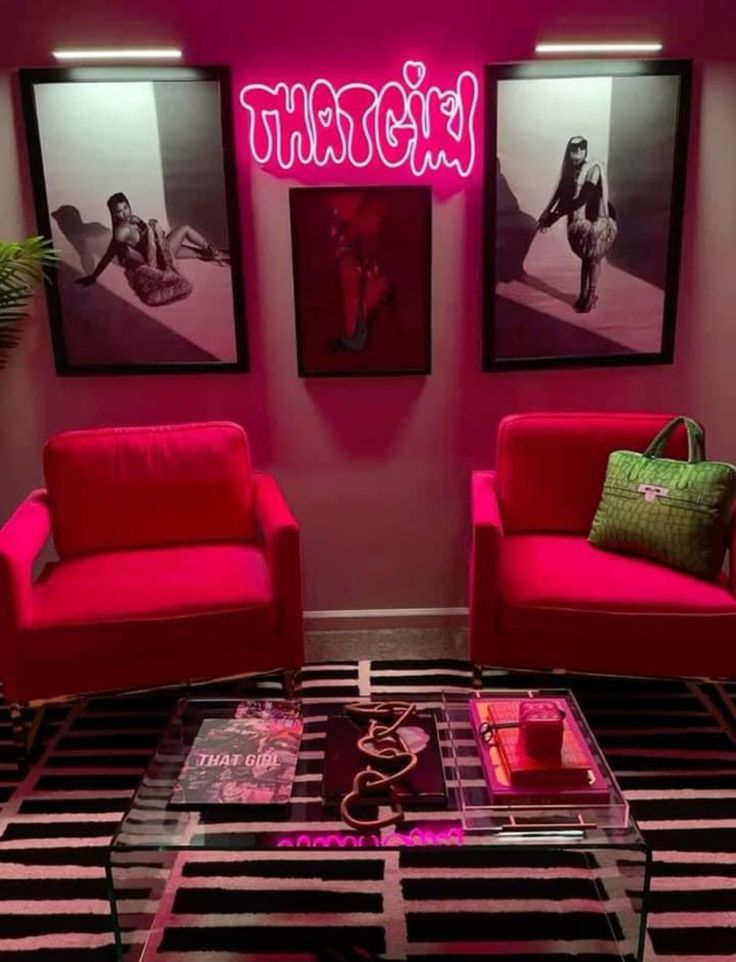 a living room with two red chairs and a coffee table