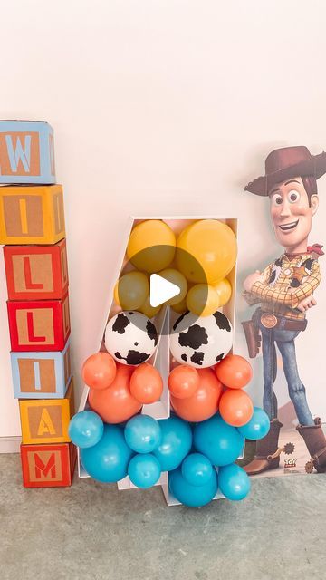 a toy story book with balloons and toys in front of it, along with an image of woody the cowboy