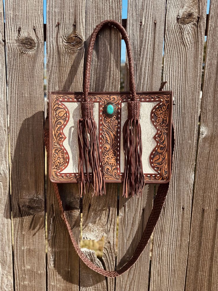 Hand made tote bag with beautiful hand tooling and genuine leather & cowhide. Conceal Carry Hidden Compartment Western Hand-tooled Bag For Daily Use, Western Hand Tooled Bags For Daily Use, Western Style Hand-tooled Bag For Daily Use, Western Style Hand-tooled Bags For Everyday Use, Western Style Hand Tooled Brown Bag, Western Leather Shoulder Bag For Everyday Use, Western Style Leather Shoulder Bag For Everyday Use, Western Style Brown Bags For Daily Use, Western Hand Tooled Travel Bag