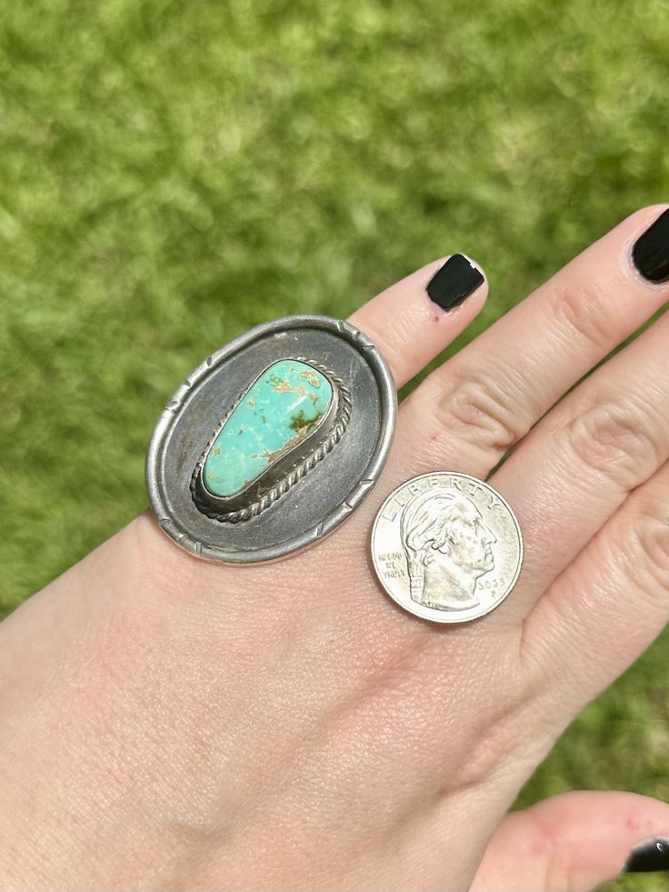 now this one right here... such a stunning ring! | vintage Turquoise & Sterling silver ring | the stone is blue/green in color with brown matrix and it's  sitting on a large round Sterling piece, almost like a shadow box style? not sure what to call it. it's such a unique piece |  It's about 2" Long and 1 1/2" wide | The stone is a little loose however, The stone is secure & we don't have any concerns with it but it's just something to note | this is a vintage piece and it's being sold *AS IS* | Southwestern Style Turquoise Ring With Patina, Untreated Round Turquoise Collectible Ring, Vintage Oval Turquoise Ring, Unique Turquoise Ring With Large Round Stone, Vintage Round Turquoise Ring, Vintage Turquoise Ring Stamped 925, Vintage Turquoise Round Ring, Vintage Green Turquoise Ring, Collectible Stamped 925 Turquoise Ring