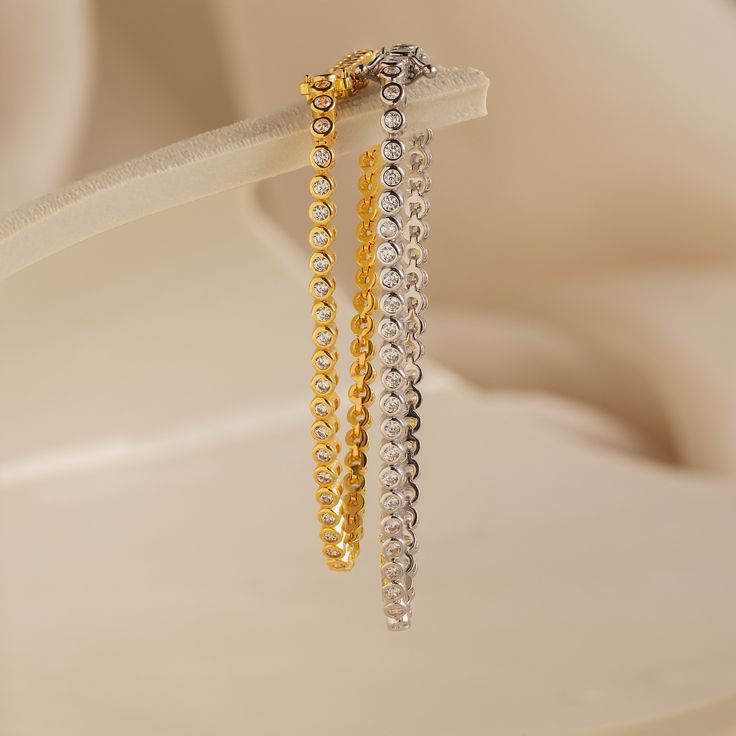 Your wedding day is a time for you to sparkle and be the center of attention. Accentuate your romantic ensemble with our Diamond Bezel Tennis Bracelet. Available in 3 lengths, this minimalist gemstone bracelet can be chosen based on the fit you need, making it an even more personalized bridal gift. Finish/Material: 18K Gold Over Brass ∙ Rhodium Over Brass Featuring ~3mm Bezels with ~2mm CZ Diamond Stones Part of our Diamond & Pavé Collection Model showcases a glamorous, statement look featuring