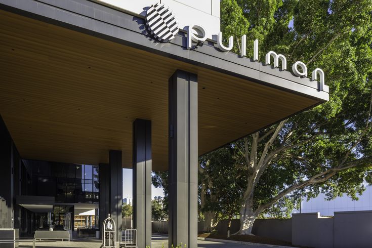 the entrance to an office building with trees in the background