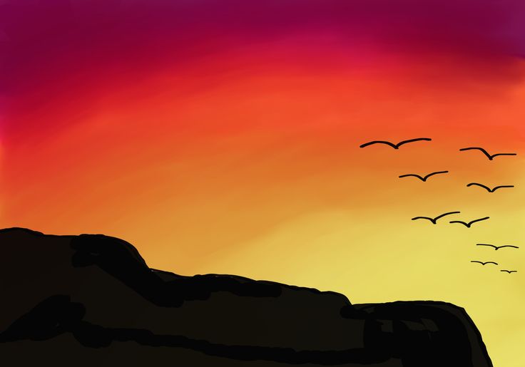 birds flying in the sky over a mountain at sunset