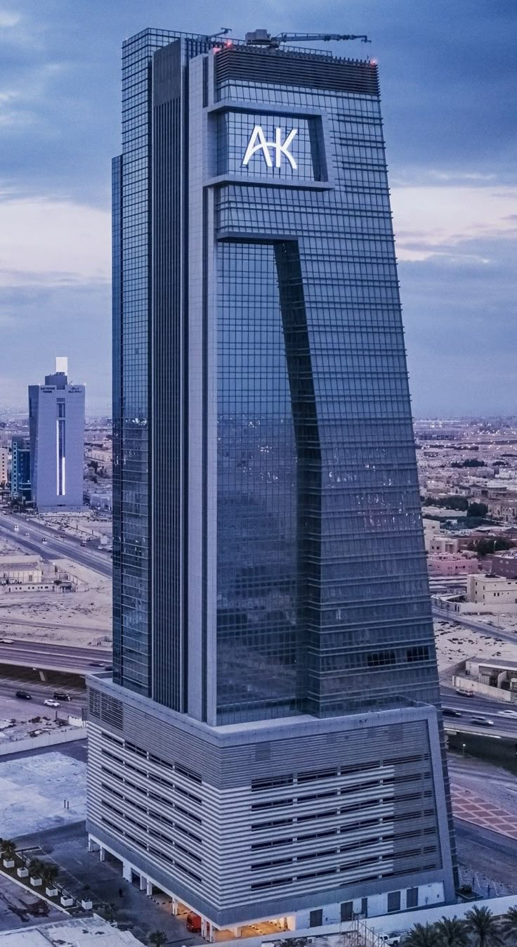 an aerial view of a tall skyscraper with the ak logo on it's side