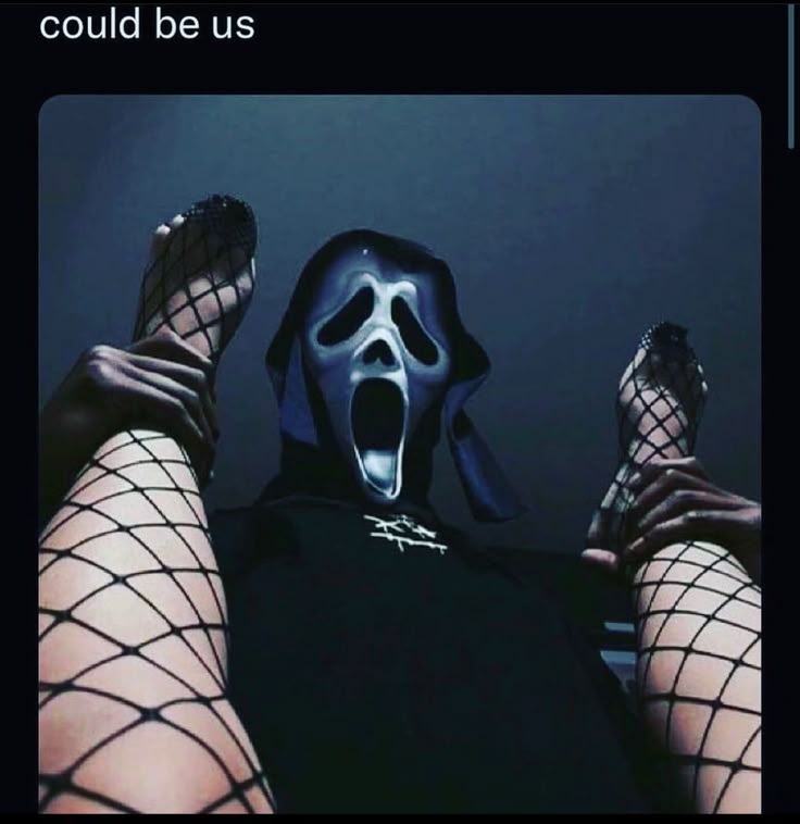 a person with their feet in fishnet stockings and a mask on, holding up his hands