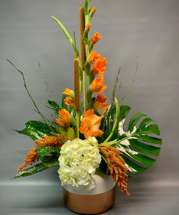 an arrangement of flowers in a white vase