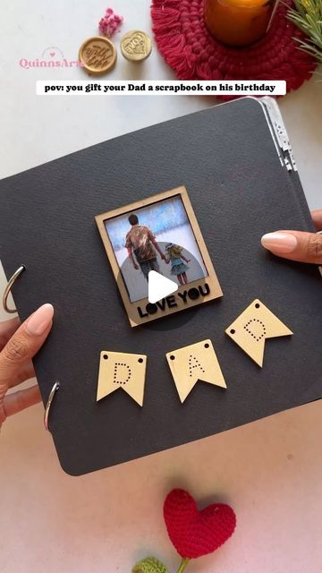 someone is holding up a photo frame with the words dad and two hearts on it