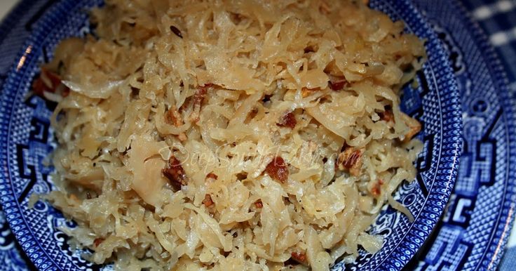 a blue plate topped with rice and meat on top of a checkered table cloth