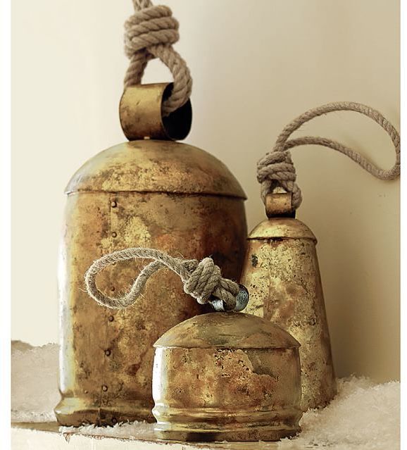 an assortment of bells on top of a shelf