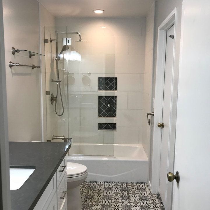 a bathroom with a sink, toilet and bathtub next to a walk in shower