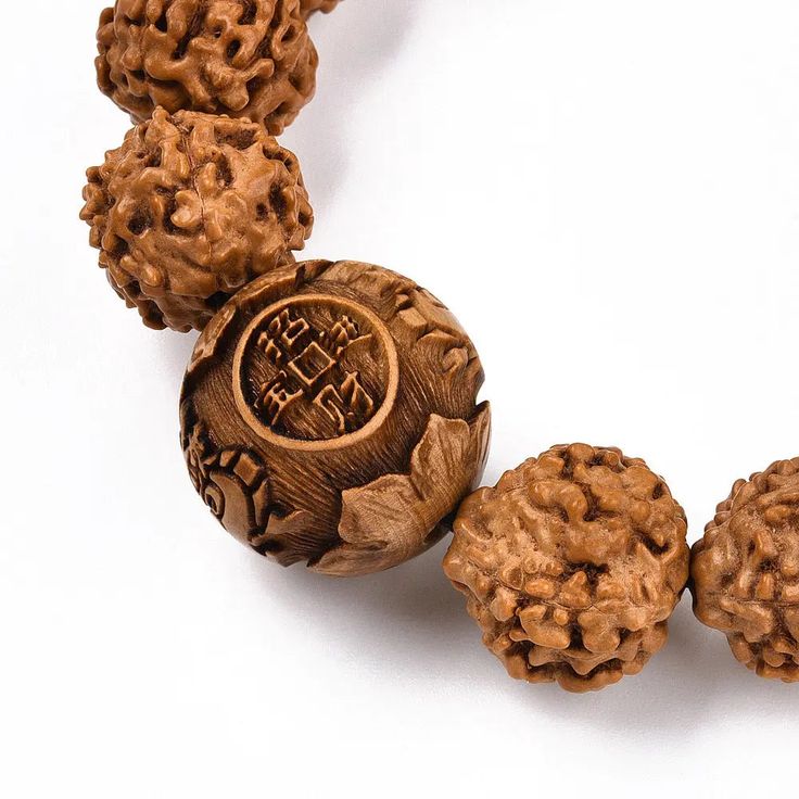 Introducing our latest addition - the Rudraksha Bracelet with 15mm beads! This stunning piece not only looks great but also has spiritual significance. Rudraksha beads are believed to have healing properties and can bring peace and clarity to the wearer. Get yours today and experience the positive energy it brings. The rudraksha is the perfect choice for conquering your enemies and also to enjoy a sound physical and mental health. Anyone, irrespective of gender, cultural, ethnic, geographical or Spiritual Round Bracelets For Festivals, Holistic Round Beaded Bracelets For Meditation, Holistic Beaded Bracelets For Meditation, Spiritual Wooden Beads Bracelets For Festivals, Adjustable Carved Beaded Bracelets For Spiritual Style, Beaded Bracelets For Meditation And Festivals, Spiritual Stretch Bracelet With Large Beads For Gifts, Spiritual Round Beads Bracelets For Meditation, Large Beads Bracelets For Meditation