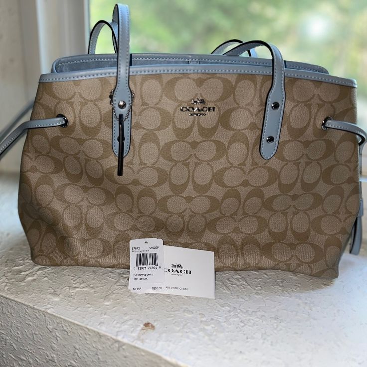 Brand New Never Used. Originally $350.00 With Tags. Beige Signature Coated Canvas Bag With Dust Bag Included, Beige Signature Coated Canvas Bag With Dust Bag, Elegant Satchel In Signature Coated Canvas, Elegant Satchel Bag In Signature Coated Canvas, Signature Coated Canvas Satchel Shoulder Bag For Shopping, Elegant Bags With Handles In Coated Canvas, Elegant Top Handle Bag In Signature Coated Canvas, Elegant Signature Coated Canvas Satchel For Shopping, Elegant Coated Canvas Shoulder Bag For Errands