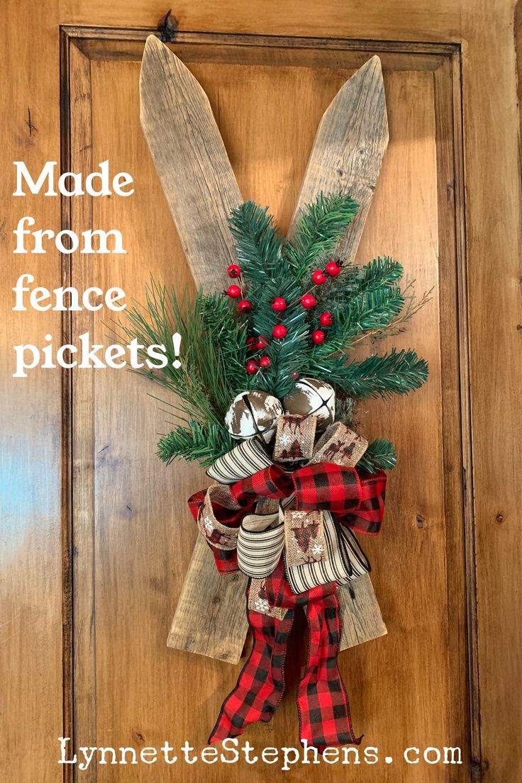 a christmas door hanger made from old fence pickets and plaid ribbon with the words made from fence pickets on it