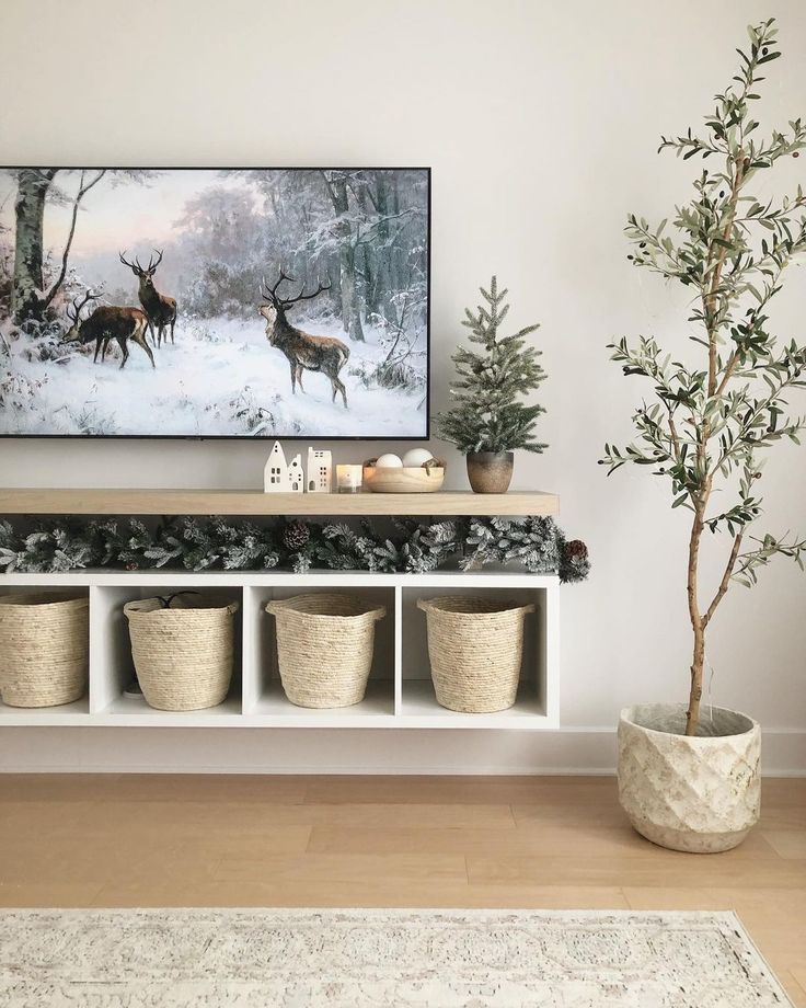 a living room filled with furniture and a painting on the wall above it's shelf