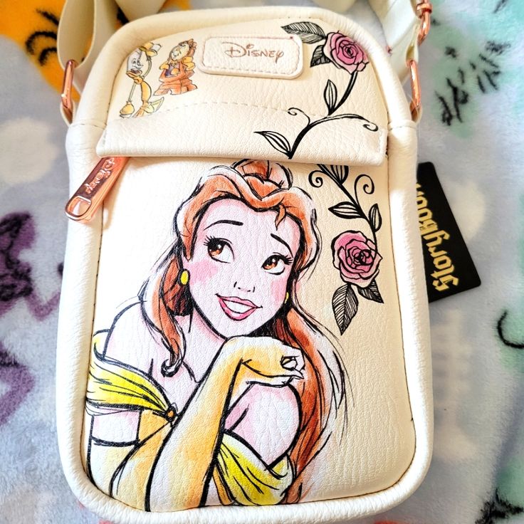 a hand painted disney princess purse on a bed