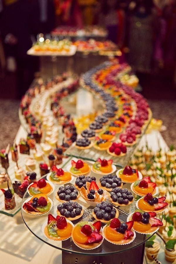 an assortment of desserts and pastries on a buffet table