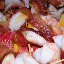 shrimp and bacon skewers with toothpicks on them