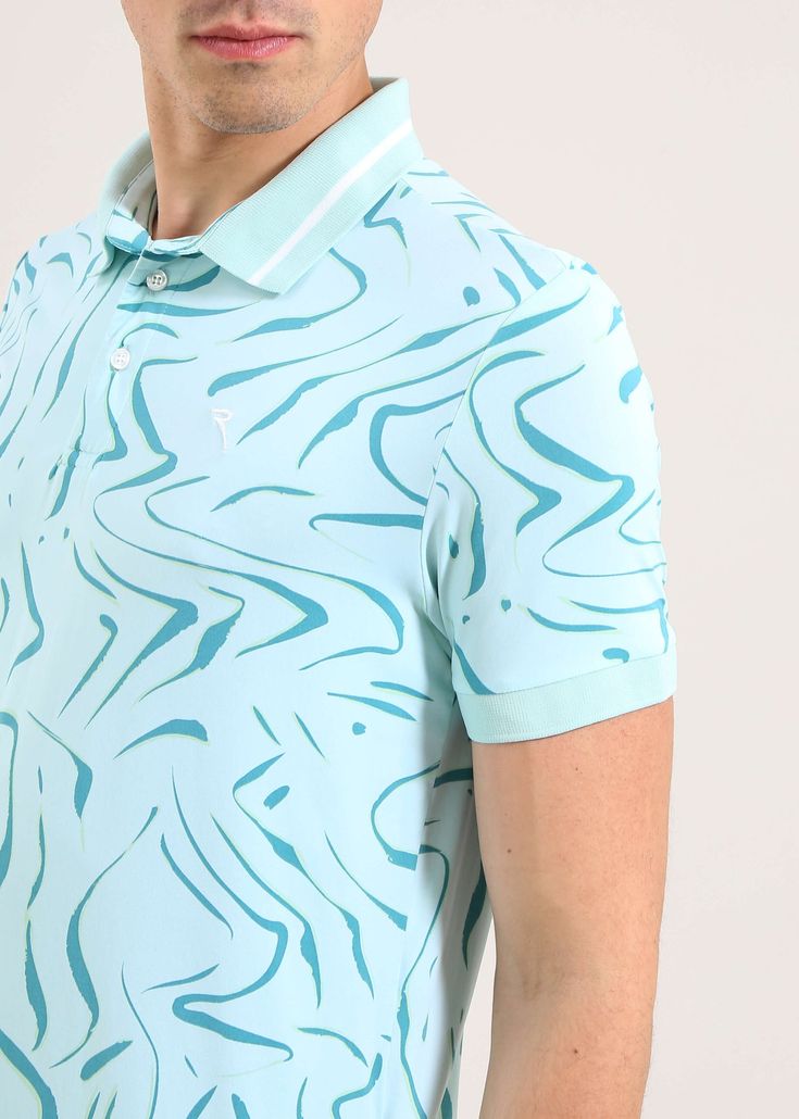 a man wearing a polo shirt with blue swirls on it