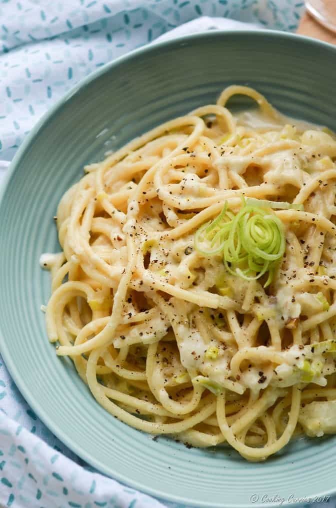 a blue bowl filled with pasta and sauce