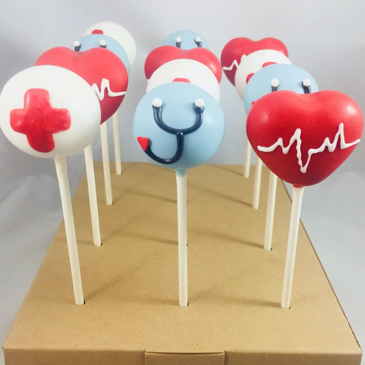 several heart shaped lollipops on sticks with a stethoscope painted on them