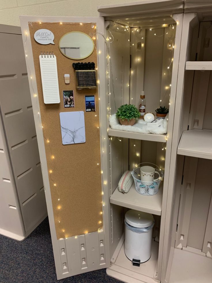 an open cabinet with lights and magnets on it