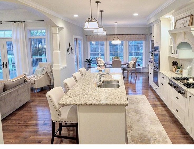 a large kitchen with an island in the middle and lots of counter space on one side