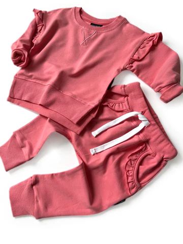 Little Bipsy Designed with style and comfort in mind, our classic joggers are the perfect go-to pants that will have your little one ready for play all day, every day. Details: Color: Strawberry Flutter detail on pockets Elastic waistband Functioning drawstring Slight drop crotch providing the perfect relaxed fit Front pockets perfect for storing treasures and treats Grow with me ribbed ankle cuffs 95% cotton | 5% spandex Buttery soft with the perfect amount of stretch Machine wash with like col Playful Cotton Joggers For Loungewear, Playful Cotton Sweatpants With Elastic Waistband, Cotton Sweatpants With Elastic Waistband For Playtime, Casual Cotton Sweatpants For Playtime, Casual Cotton Joggers For Playwear, Spring Pink Joggers With Ribbed Cuffs, Cotton Sweatpants For Spring Playwear, Pink Cotton Pants With Elastic Cuffs, Casual Playtime Pants