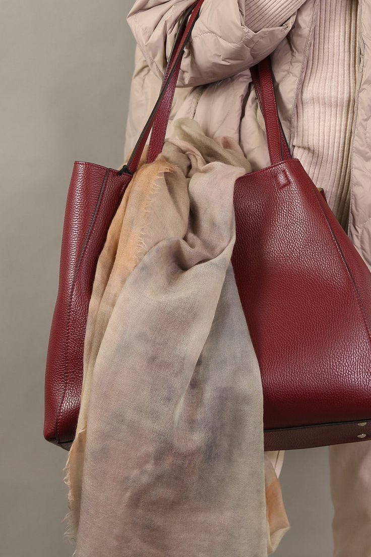 The full-grain pebbled calfskin Totona Tote is hand-made in Italy and features covered snaps, a four-way closure, a suede-lined interior with a zipper, and two easy-access pockets. Details Hand Made in Italy Italian Leather Made by Daniel&Bob Dimensions: 15 3/4" W X 13" H X 6" D Handle drop in 10" Product code: TOTONA HANDBAGS 549.38-2223 - WINE - OS Everyday Fall Bag With Pebbled Texture, Fall Travel Bag With Pebbled Texture, Classic Burgundy Shoulder Bag For Fall, Classic Pebbled Leather Shoulder Bag For Fall, Business Leather Bags With Pebbled Texture, Classic Fall Pebbled Leather Shoulder Bag, Fall Pebbled Leather Bag With Leather Lining, Fall Shoulder Bag In Soft Pebbled Leather, Brown Leather Shoulder Bag With Pebbled Texture