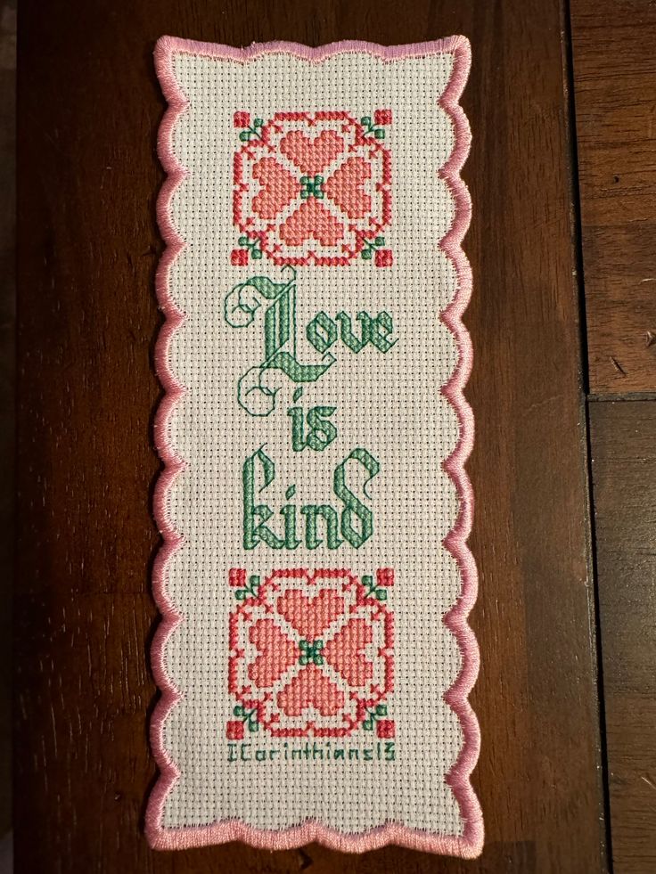 a cross - stitch pattern with the words love is bliss and two hearts on it