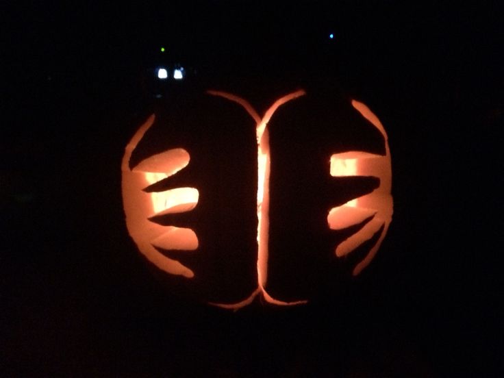 a pumpkin carved to look like two hands