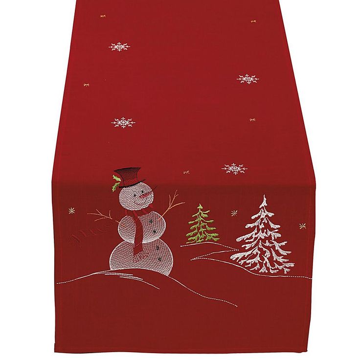 a red table runner with a snowman on it