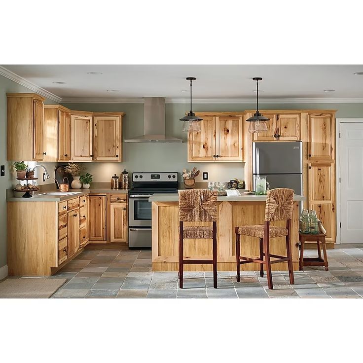 a kitchen filled with lots of wooden cabinets and chairs next to a stove top oven