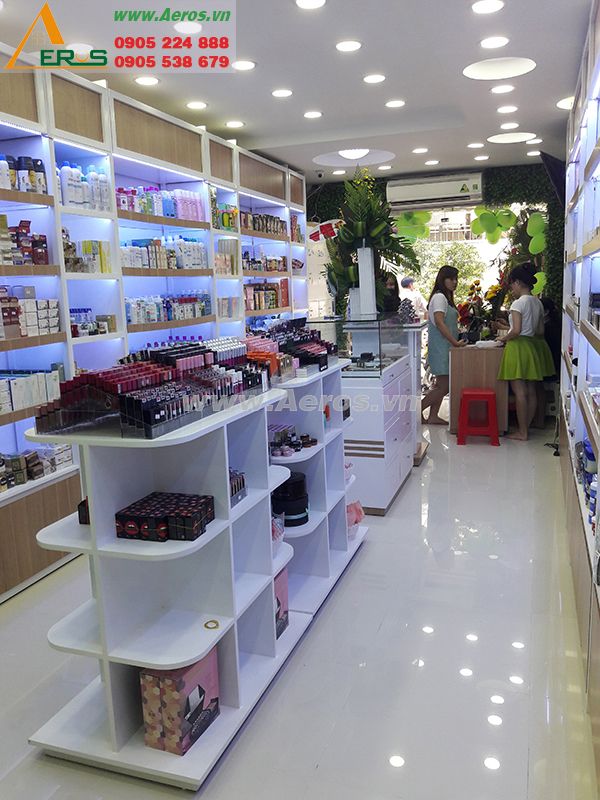 the inside of a cosmetics store with shelves full of products and people looking at them