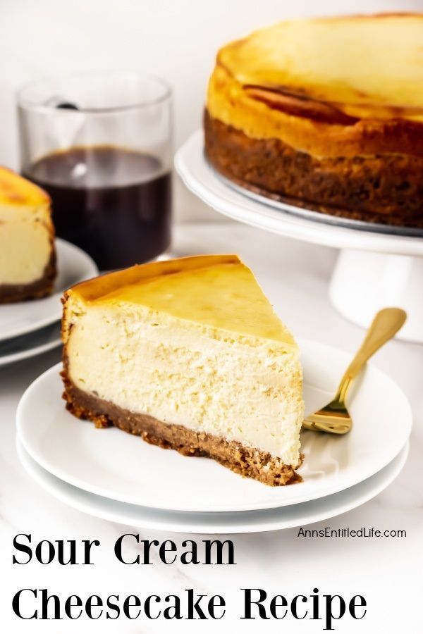 Close-up of a piece of sour cream cheesecake on a white plate, gold fork on the plate. The remaining cheesecake is on a white cakedish in the background, a cup of coffee to the left. Cheesecake Recipe With Sour Cream, Small Cheesecake Recipe, Cake Recipe With Sour Cream, Recipes Using Sour Cream, Recipe With Sour Cream, Easy Cheesecake Recipe, Cream Cheese Cheesecake, Small Cheesecakes, Sour Cream Desserts