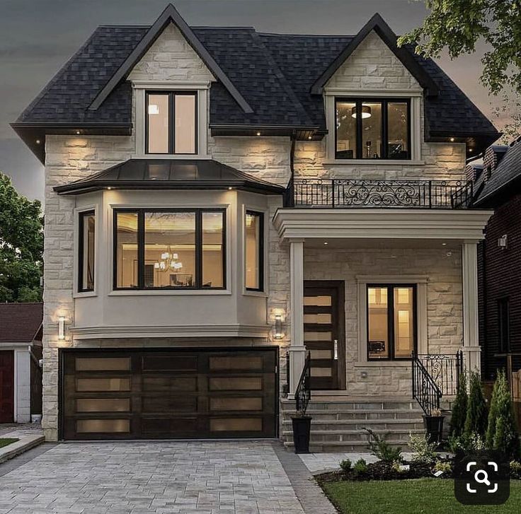 a two story house with an attached garage and stairs leading up to the second floor